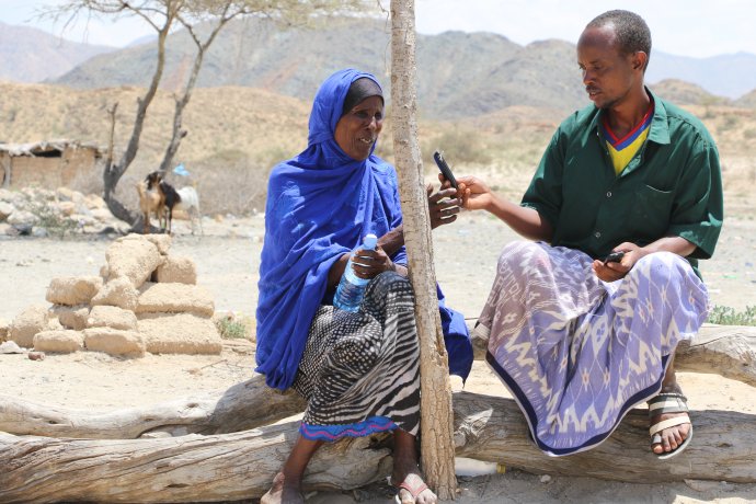 Somalian lady reclaiming electronic cash on her phone