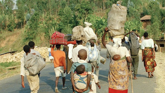 Rwandan refugees returning from Goma on a road near Gisenyi